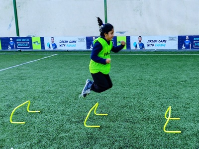 girl jumping over hurdles